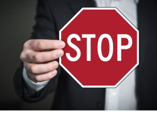 Vacinas não autorizadas na Italia, uma questão politica. Na foto, uma mãe segura uma placa com a escrita "Stop".