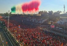 GP de Monza 2026: como 403 mil presenças movimentam o turismo na Lombardia Multidão de torcedores na pista e nas arquibancadas do Autódromo de Monza sob fumaça verde, branca e vermelha