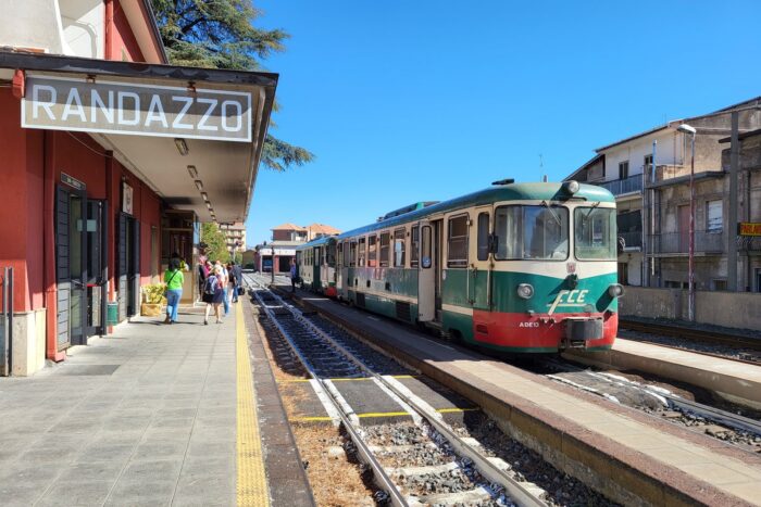 Trem verde e vermelho da Ferrovia Circumetnea parado na estação de Randazzo, na Sicília